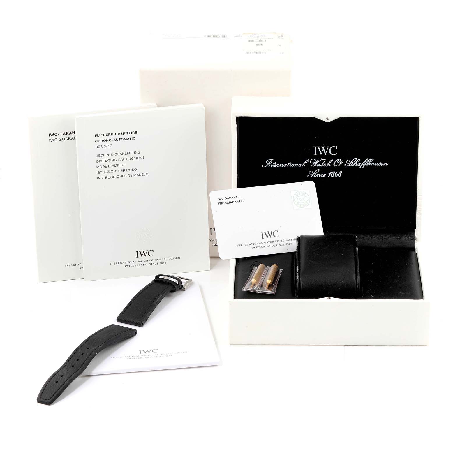 This image shows the packaging and accessories of the IWC Pilot IW388102 Men's Stainless Steel Grey Dial IW388102 Men's Stainless Steel Grey Dial model, including manuals, a strap, warranty card, and a box.