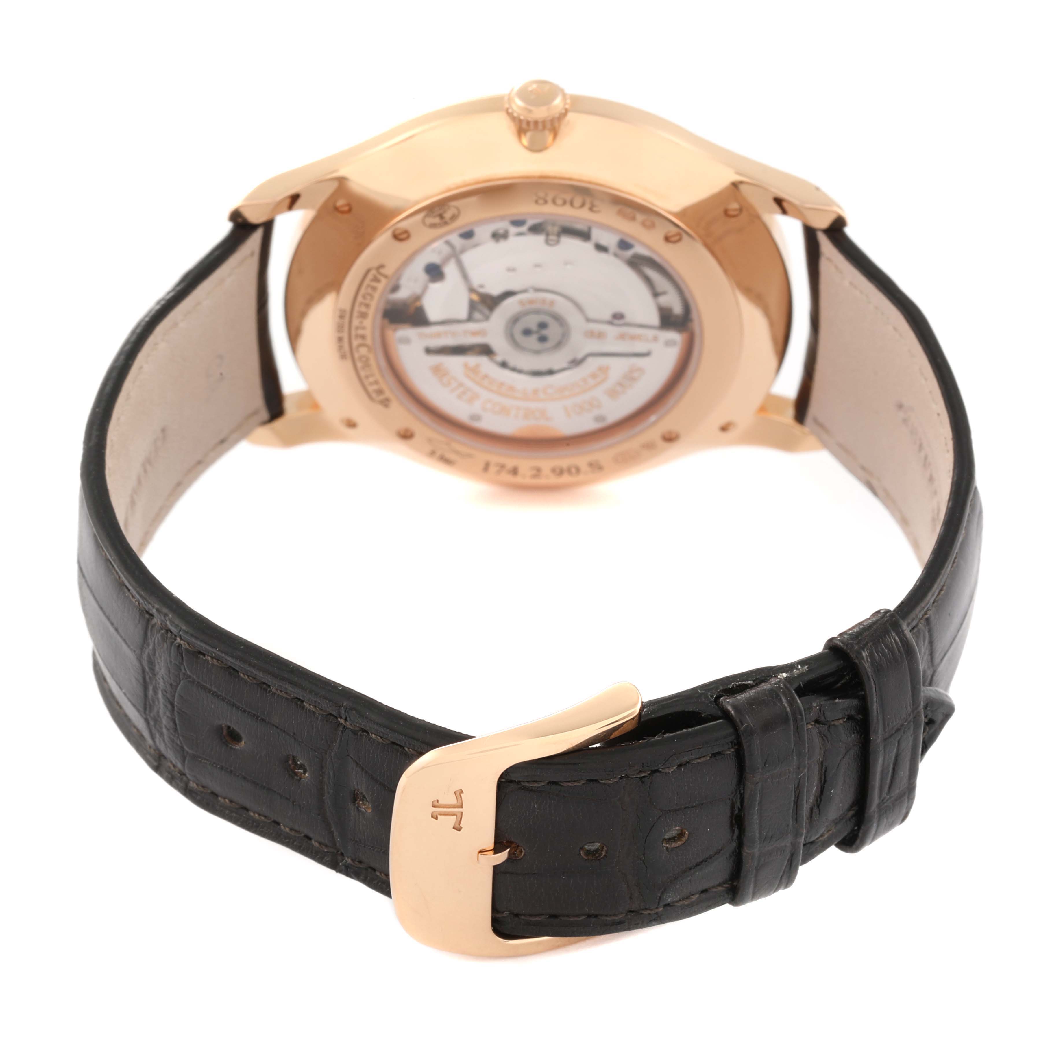 The image shows the back of a Jaeger LeCoultre Master Q1352520 Men's Rose Gold Beige Dial Q1352520 Men's Rose Gold Beige Dial model watch, highlighting the movement through a transparent case back and the leather strap with its clasp.