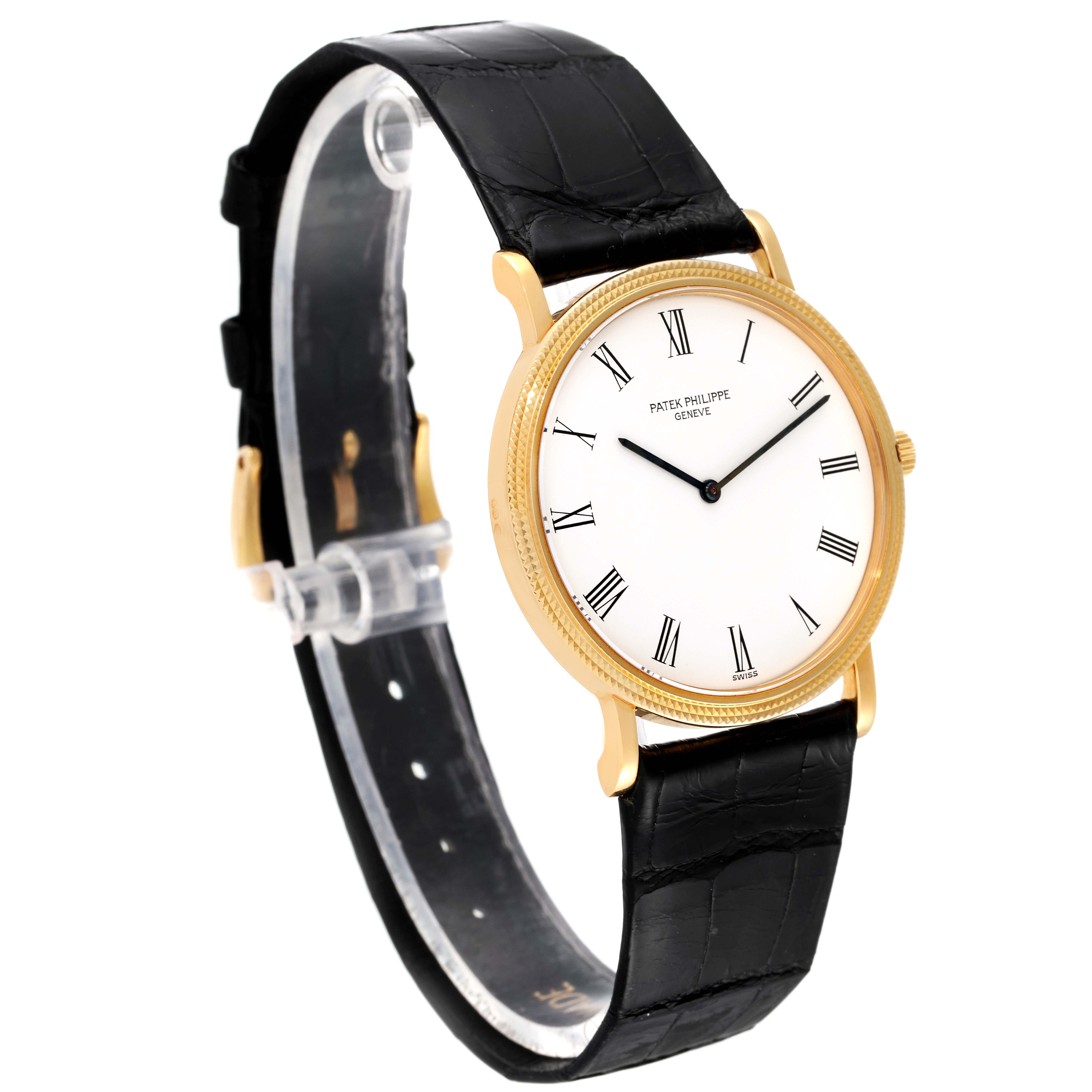 This image shows a Patek Philippe Calatrava 3520 Men's Yellow Gold White Dial 3520 Men's Yellow Gold White Dial watch from a partially angled side view, highlighting the face, bezel, and black leather strap.