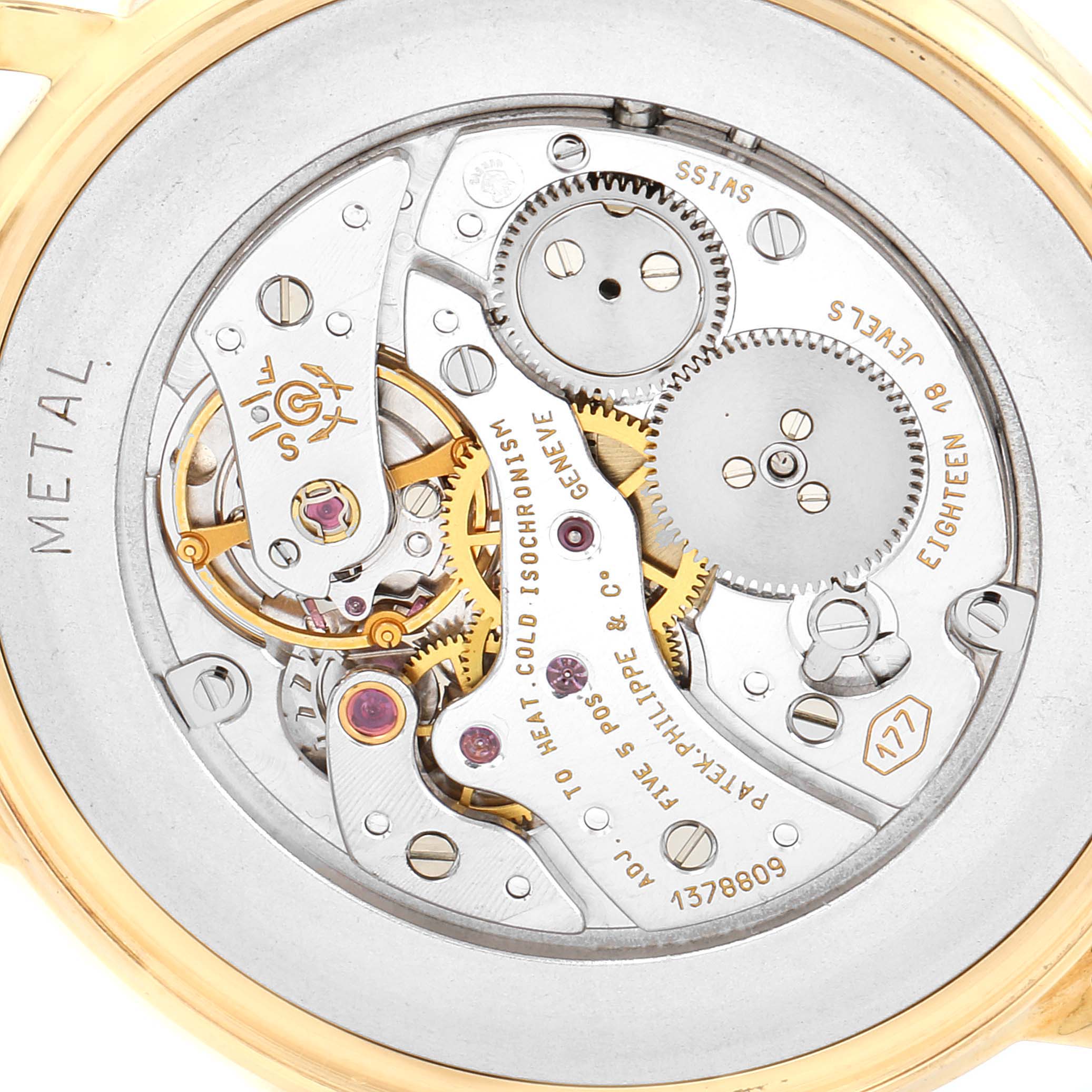 The image shows the back view of the movement mechanism of a Patek Philippe Calatrava 3520 Men's Yellow Gold White Dial 3520 Men's Yellow Gold White Dial watch, showcasing its intricate gears and components.