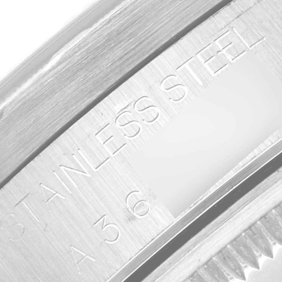 This close-up image shows the engraved "Stainless Steel" marking on the back inside part of the bezel and visible cog edge of a Rolex Date 15210 Men
s Stainless Steel Black Dial 15210 Men
s Stainless Steel Black Dial model.