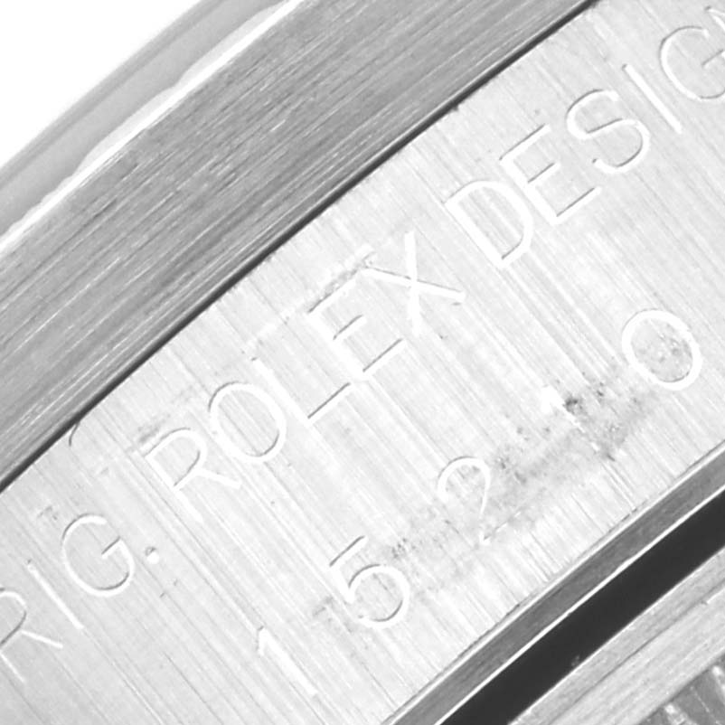 The image shows a close-up of the case side of a Rolex Date 15210 Men
s Stainless Steel Black Dial 15210 Men
s Stainless Steel Black Dial model, with engraved text reading "ROLEX DESIGN."