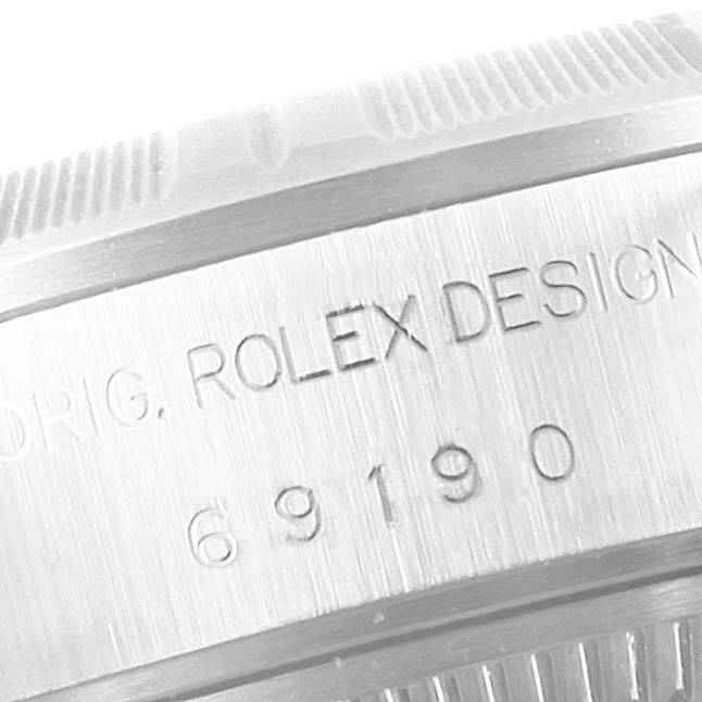 The image shows a close-up of the engraving on the side of a Rolex Date 69190 Women's Stainless Steel Blue Dial 69190 Women's Stainless Steel Blue Dial model watch, highlighting the "Rolex Design 69190" inscription.