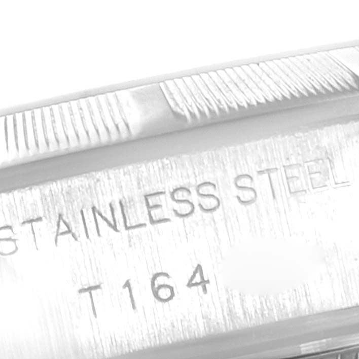 The image shows the side of a Rolex Date 69190 Women's Stainless Steel Blue Dial 69190 Women's Stainless Steel Blue Dial model watch, displaying the "STAINLESS STEEL" engraving and part of the bezel.