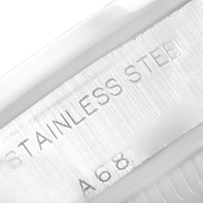 The image shows a close-up of the side engraving on the Rolex Date 79160 Women
s Stainless Steel Silver Dial 79160 Women
s Stainless Steel Silver Dial model, indicating "STAINLESS STEEL" and a partial serial number.