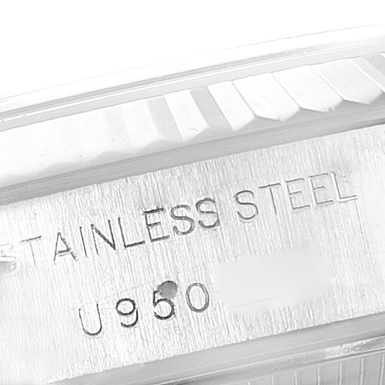 This image shows a close-up of the case and bezel of a Rolex Datejust 69174 Women
s Stainless Steel White Dial 69174 Women
s Stainless Steel White Dial watch, highlighting "STAINLESS STEEL" engraving.
