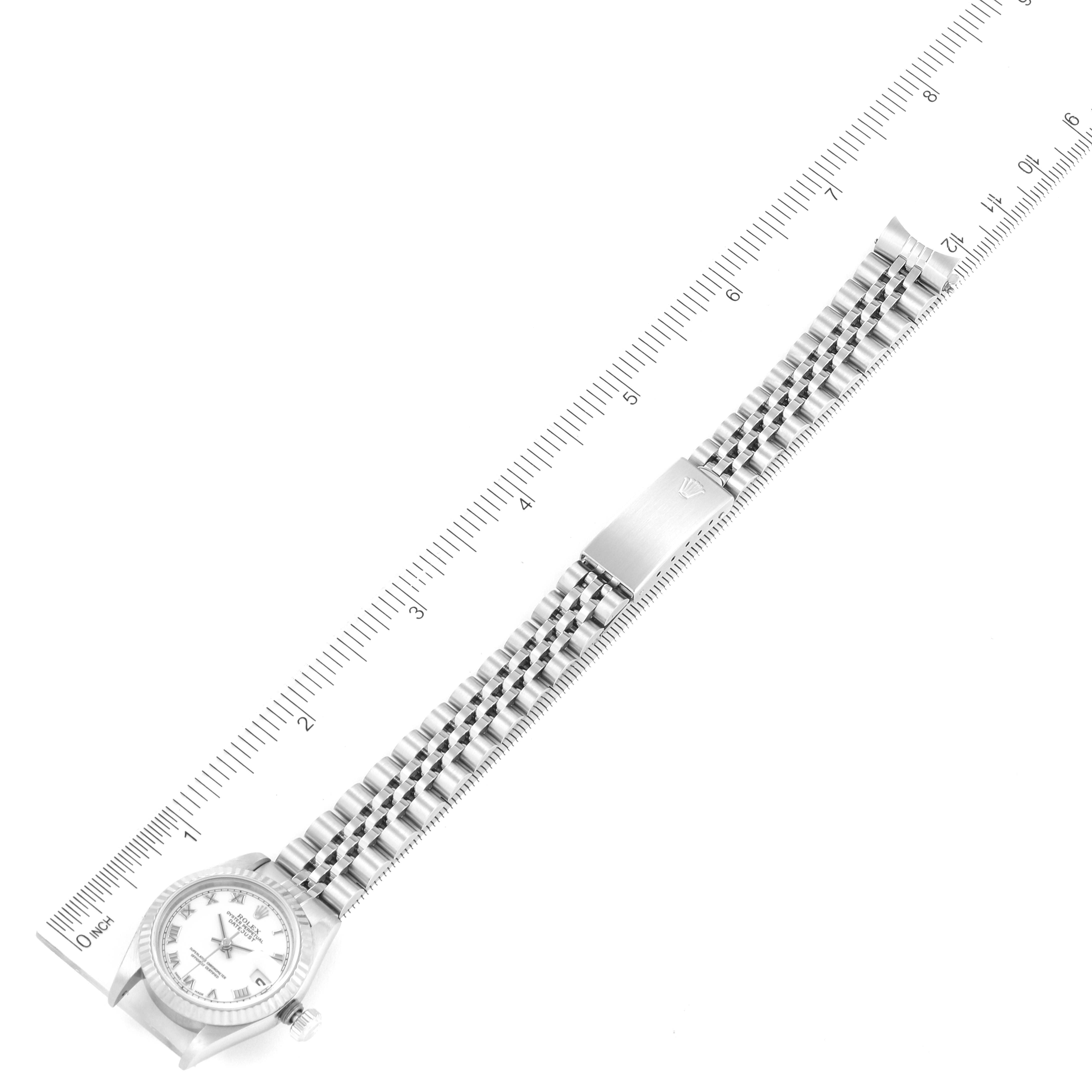 A top-down view of the Rolex Datejust 69174 Women
s Stainless Steel White Dial 69174 Women
s Stainless Steel White Dial watch with its full metal bracelet and ruler measurements alongside.