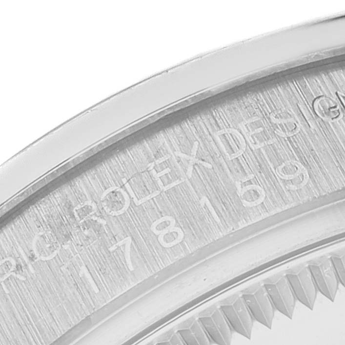 The image shows a close-up of the case back engraving and part of the fluted bezel of a Rolex President 178159 Women's White Gold Silver Dial 178159 Women's White Gold Silver Dial model watch.
