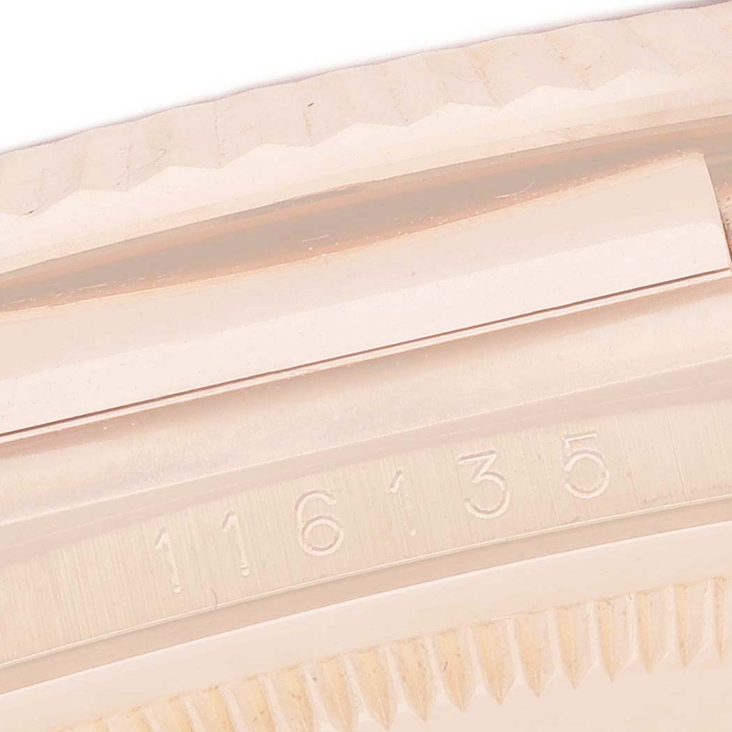 The image shows a close-up of the bezel and case edge of the Rolex Datejust 116135 Men's Rose Gold Mother of Pearl Dial, focusing on engraved serial numbers.