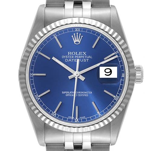 The image shows a front view of a Rolex Datejust, featuring a blue dial, fluted bezel, and silver bracelet.