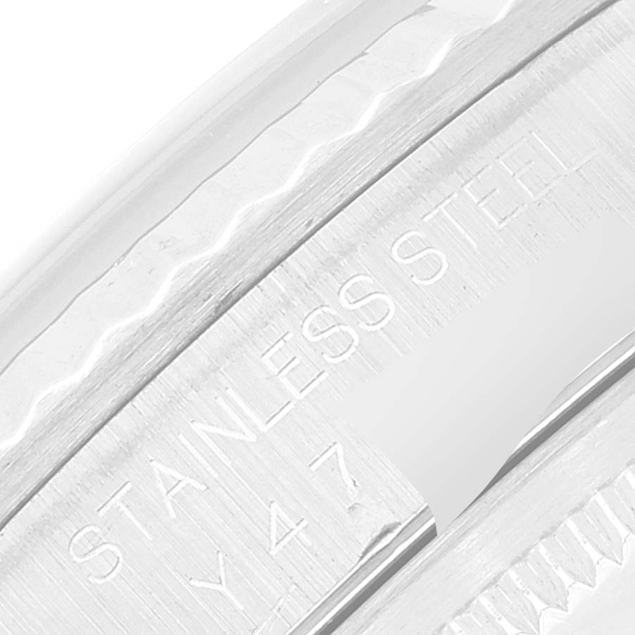 This close-up image shows the engraved "STAINLESS STEEL" marking on the side of a Rolex Datejust 16234 Men's Stainless Steel Blue Dial 16234 Men's Stainless Steel Blue Dial watch case.