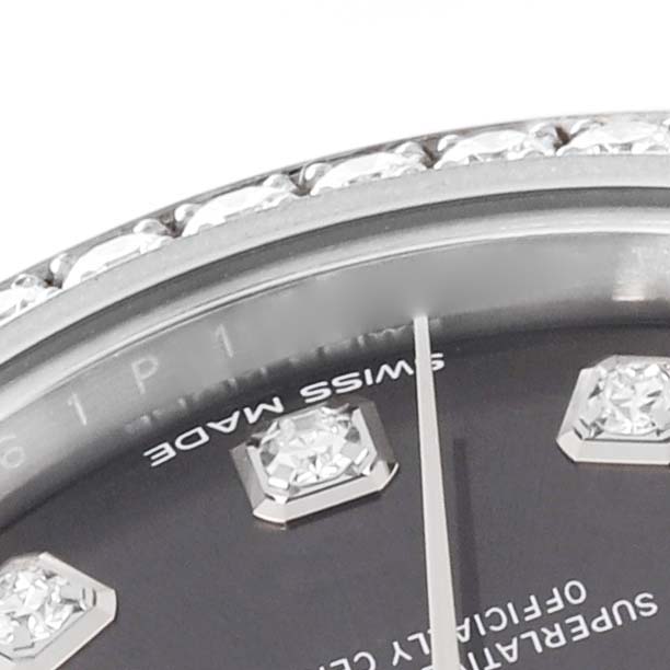 A close-up of the Rolex Datejust 279384 Women's Stainless Steel Grey Dial 279384 Women's Stainless Steel Grey Dial watch face, showing part of the dial, diamond markers, and the bezel with diamonds.