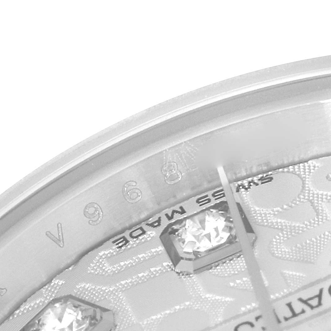 This is a close-up angle of the dial and the bezel of the Rolex Datejust 179174 Women
s Stainless Steel Silver Dial 179174 Women
s Stainless Steel Silver Dial, showcasing diamond hour markers and part of the watch
s engraving.