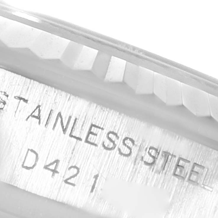 This close-up shows the fluted bezel and part of the case with engraved text of the Rolex Datejust 179174 Women
s Stainless Steel Silver Dial 179174 Women
s Stainless Steel Silver Dial model.
