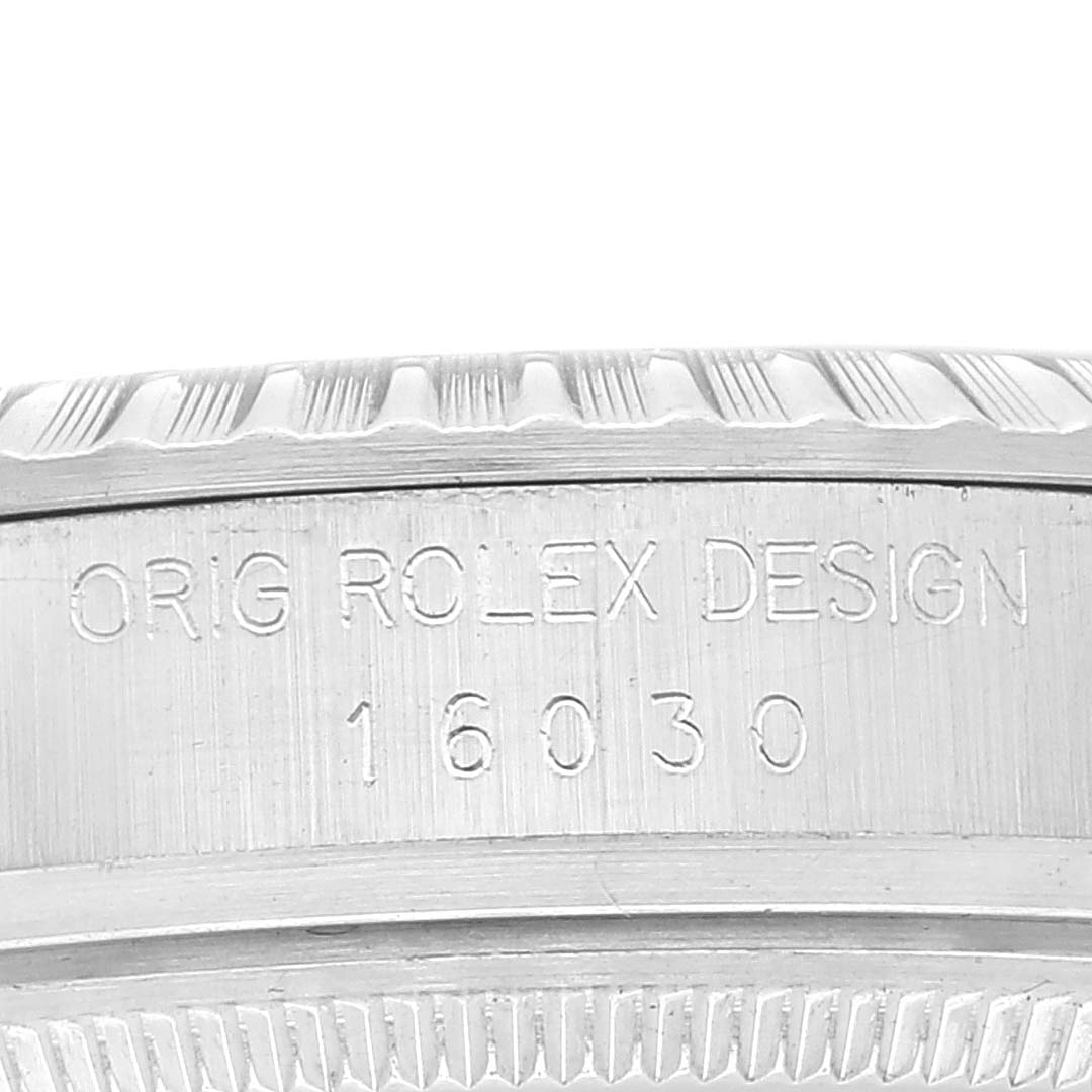 The image shows a close-up of the engraved bezel and case of a Rolex Datejust 16030 Men's Stainless Steel White Dial 16030 Men's Stainless Steel White Dial watch, model 16030.