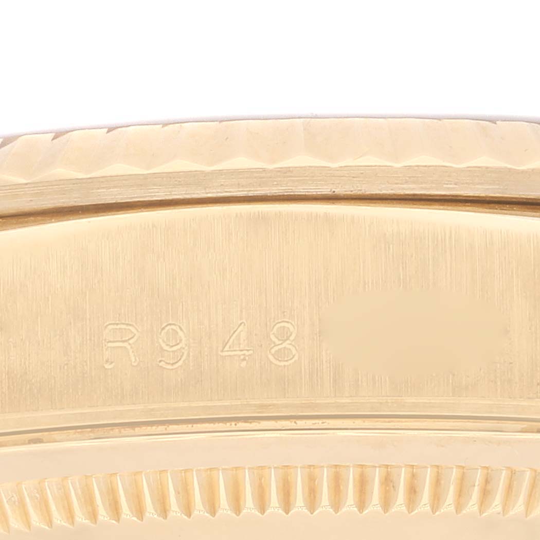 This image shows a close-up of the case side and case back edges of the Rolex President 18238 Men
s Yellow Gold Champagne Dial 18238 Men
s Yellow Gold Champagne Dial watch, featuring a visible serial number.