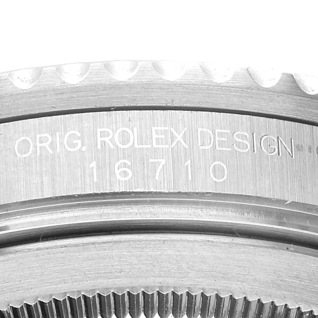 The image shows a close-up of the engraved "ORIG. ROLEX DESIGN 16710" on the bezel of a Rolex GMT-Master 16710 Men's Stainless Steel Black Dial 16710 Men's Stainless Steel Black Dial watch.