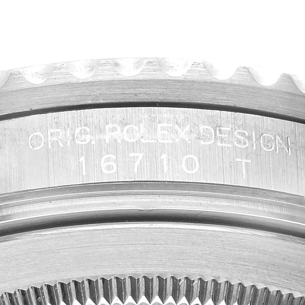 The image shows a close-up of the sidecase and bezel of the Rolex GMT-Master 16710 Men's Stainless Steel Black Dial 16710 Men's Stainless Steel Black Dial model, with the engraving "ORIG ROLEX DESIGN 16710 T."