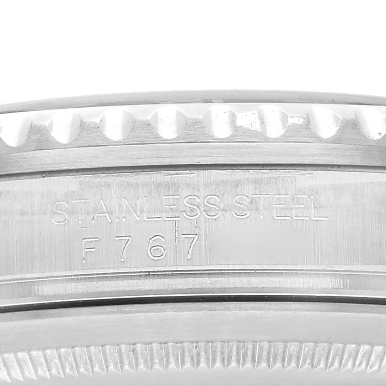 This close-up image shows the side of the bezel and case for the Rolex GMT-Master 16710 Men's Stainless Steel Black Dial 16710 Men's Stainless Steel Black Dial, displaying its stainless steel engraving.