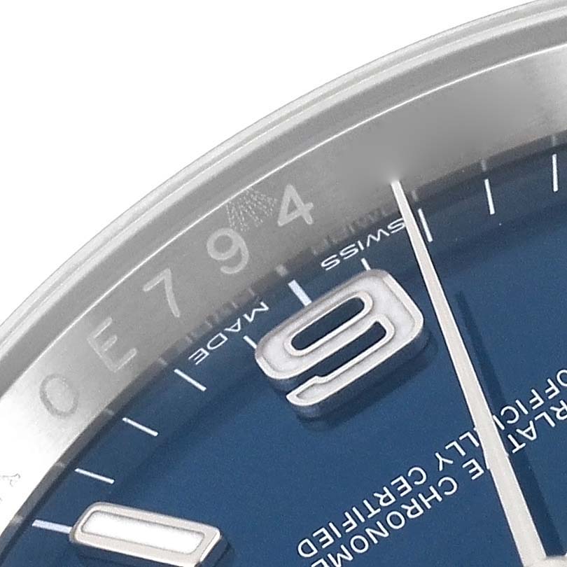 This close-up angle shows part of the dial, numbers, and markings on a Rolex Oyster Perpetual 116000 Men's Stainless Steel Blue Dial 116000 Men's Stainless Steel Blue Dial watch.