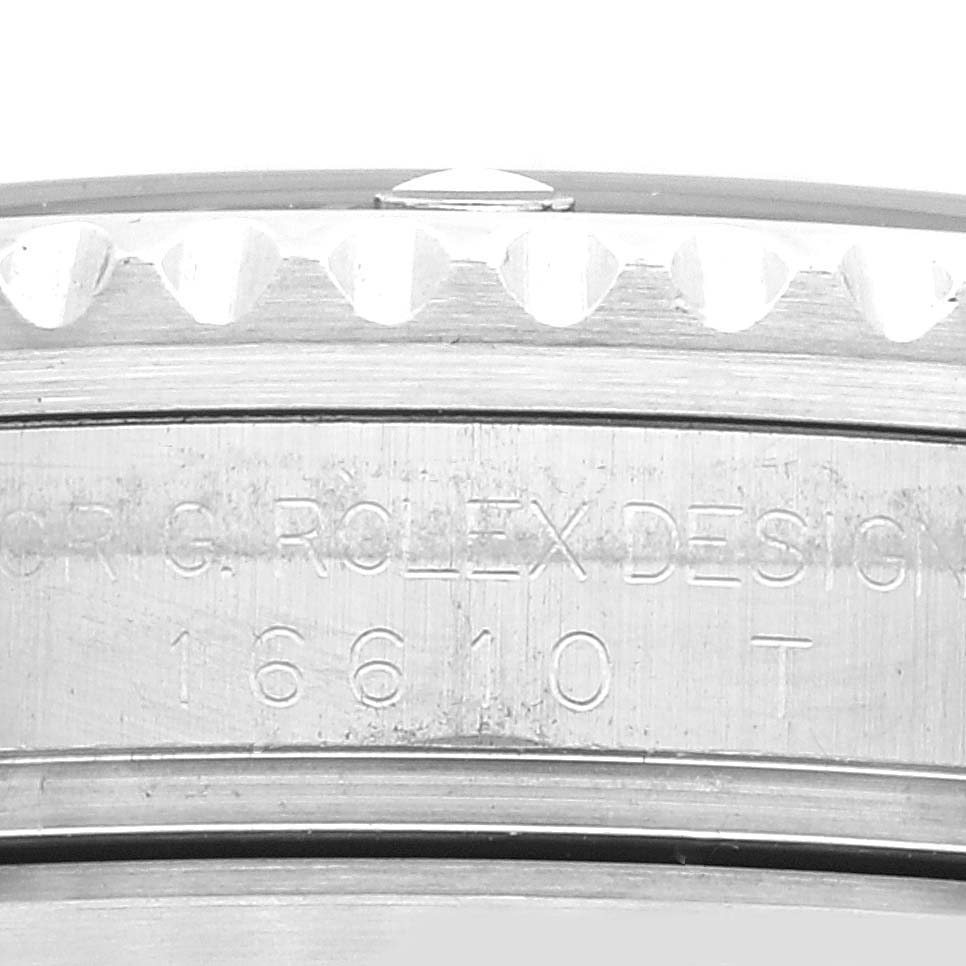 The image shows a close-up view of the side of a Rolex Submariner 16610 Men's Stainless Steel Black Dial 16610 Men's Stainless Steel Black Dial watch case with the model number 16610 T engraved.