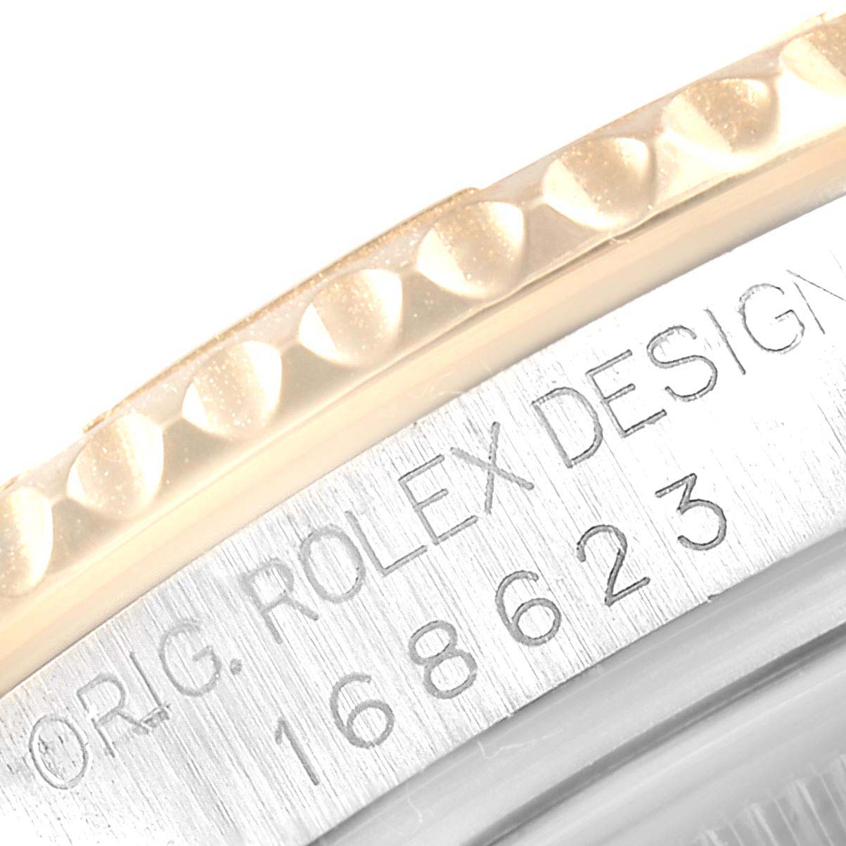 This close-up image of a Rolex Yacht-Master 168623 Men
s Steel and Gold (two tone) Grey Dial 168623 Men
s Steel and Gold (two tone) Grey Dial watch shows the edge of the bezel and part of the engraved case with the model number.