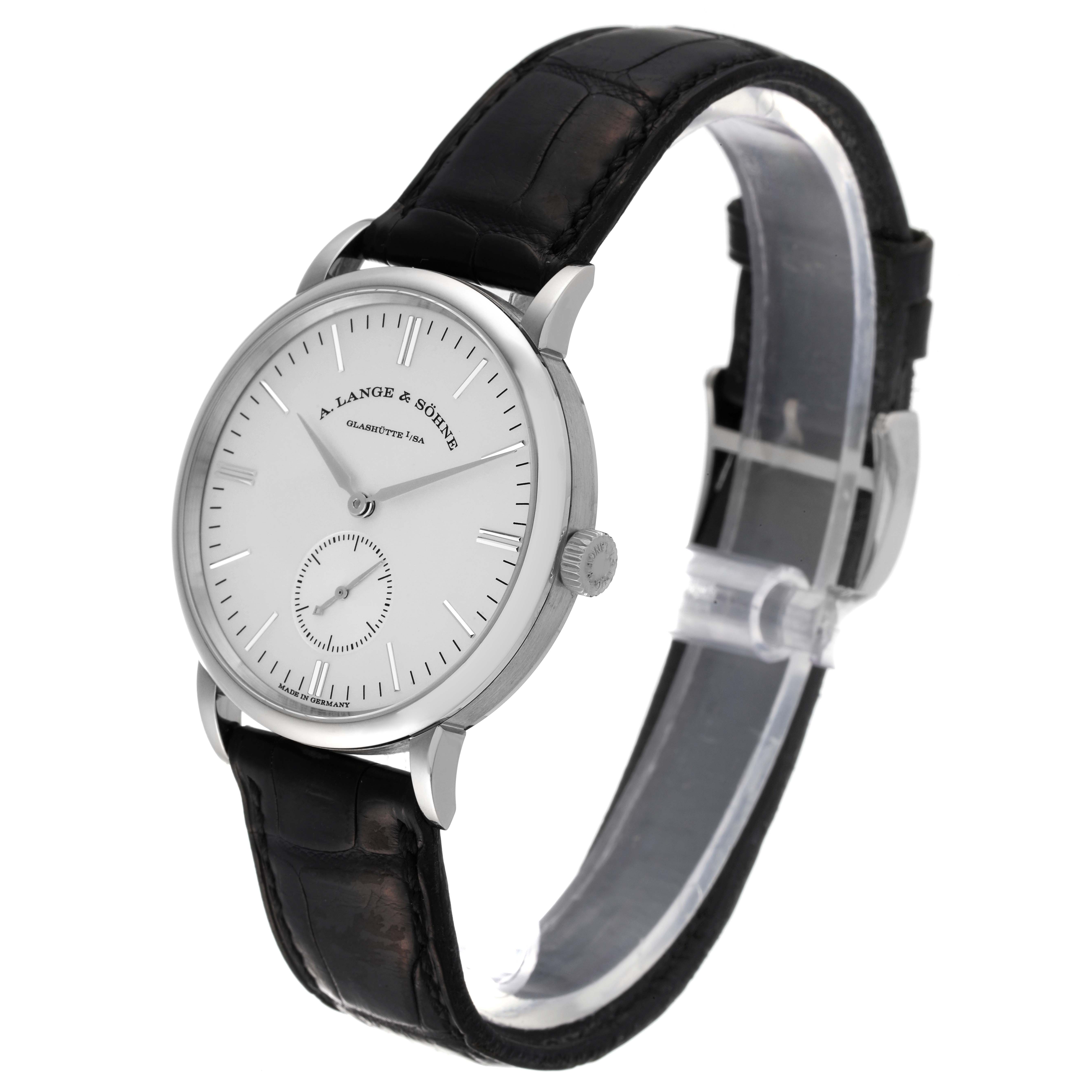 The image shows a side angle view of the A. Lange 
Sohne Saxonia 219.026 Men
s White Gold Silver Dial watch, highlighting the dial, crown, and strap.