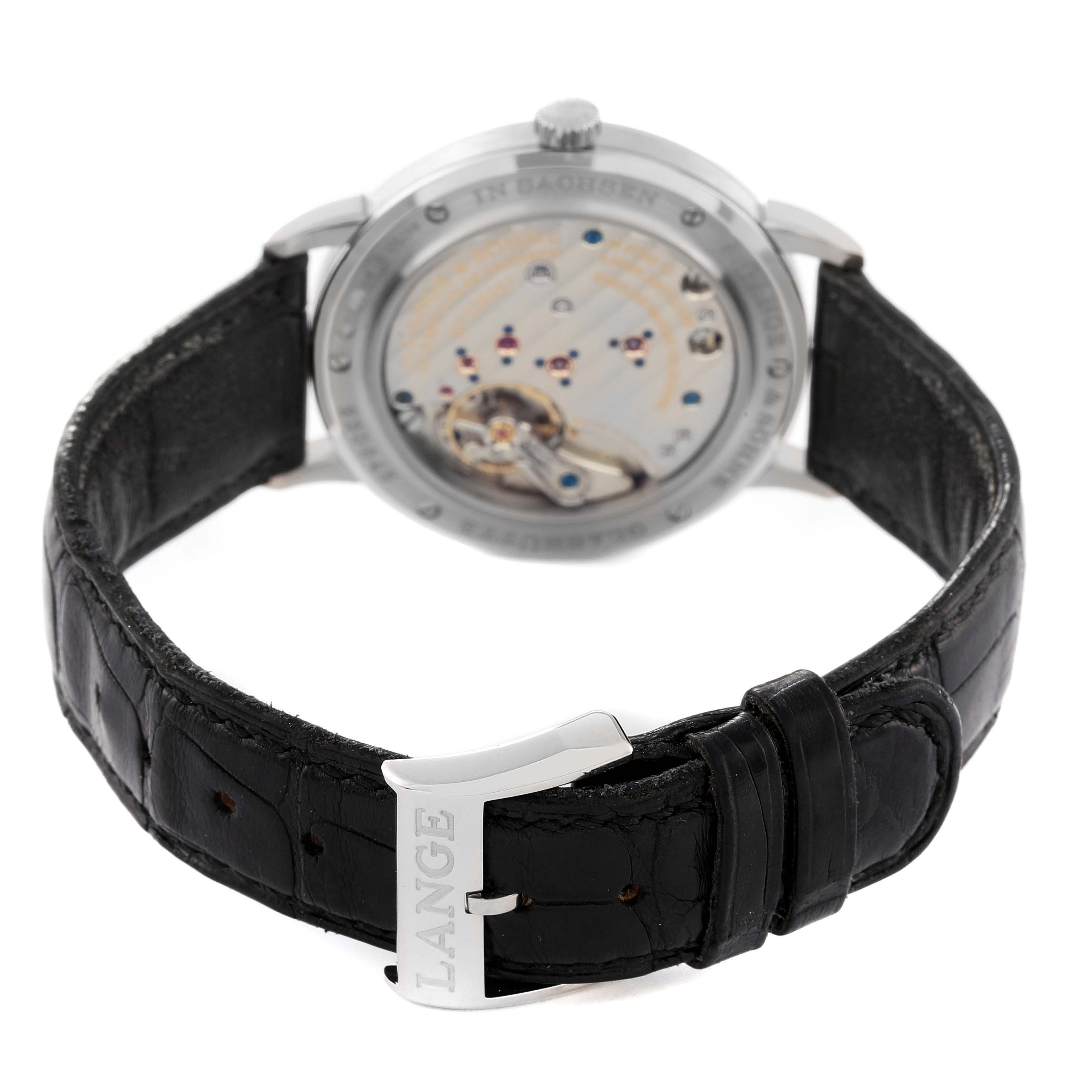 The image shows the back of the A. Lange 
Sohne Saxonia watch, highlighting the movement and the black leather strap with "LANGE" on the clasp.