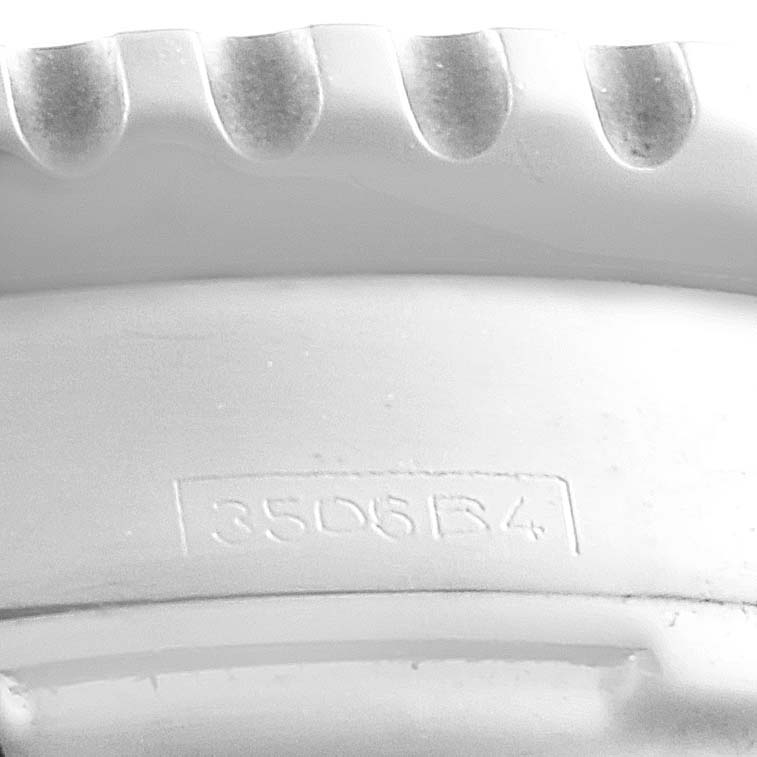 This image shows a close-up view of the engraved serial number and the edge of the bezel on a Breitling Navitimer A23322 Men
s Stainless Steel Black Dial A23322 Men
s Stainless Steel Black Dial watch.