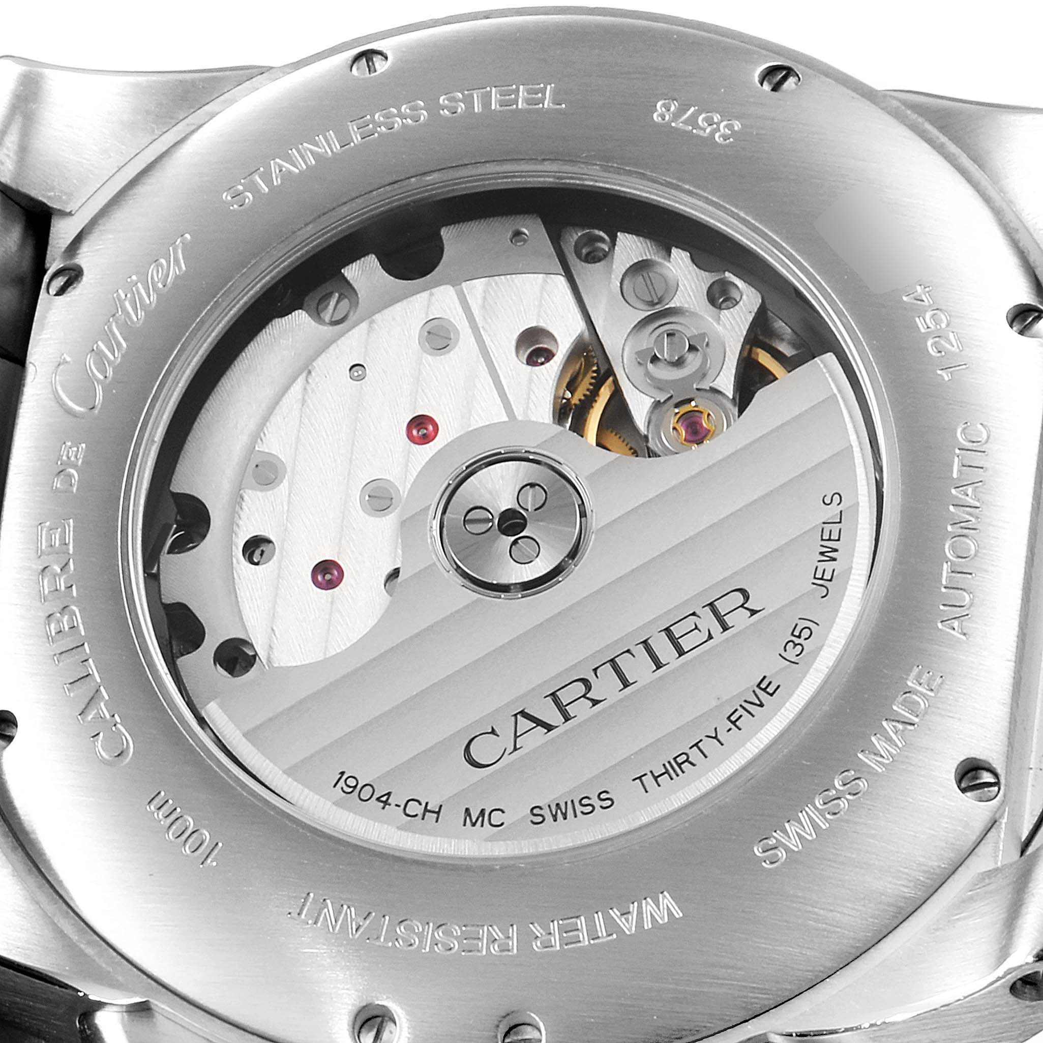 The image shows the case back and internal mechanism of the Calibre de Cartier watch by Cartier, highlighting its automatic movement.