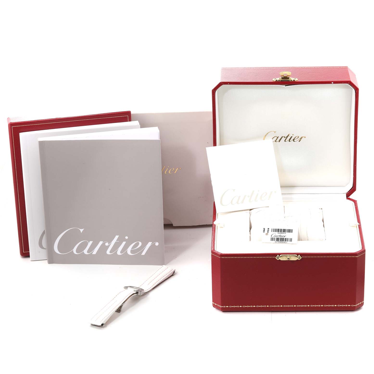 This image shows the Cartier Roadster W62054V3 Women's Stainless Steel Pink Dial W62054V3 Women's Stainless Steel Pink Dial watch box and packaging accessories from a front angle, including manuals and an extra strap.