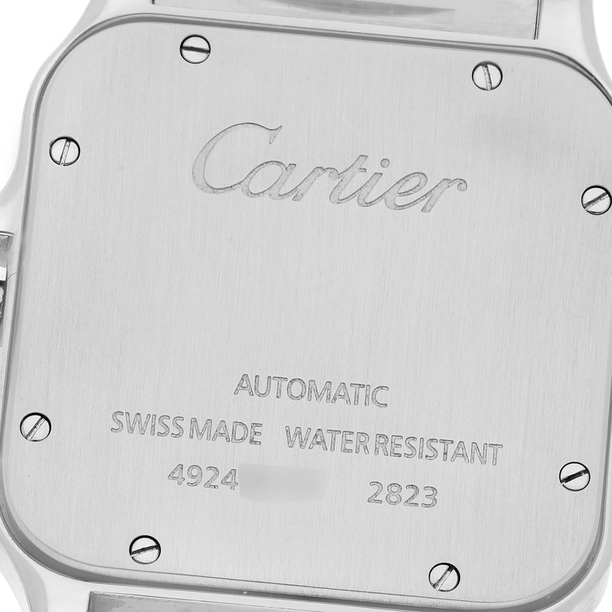 The image shows the back case of a Cartier Santos W20099C4 Men's Stainless Steel Silver Dial W20099C4 Men's Stainless Steel Silver Dial model watch, displaying engraved text and screws.