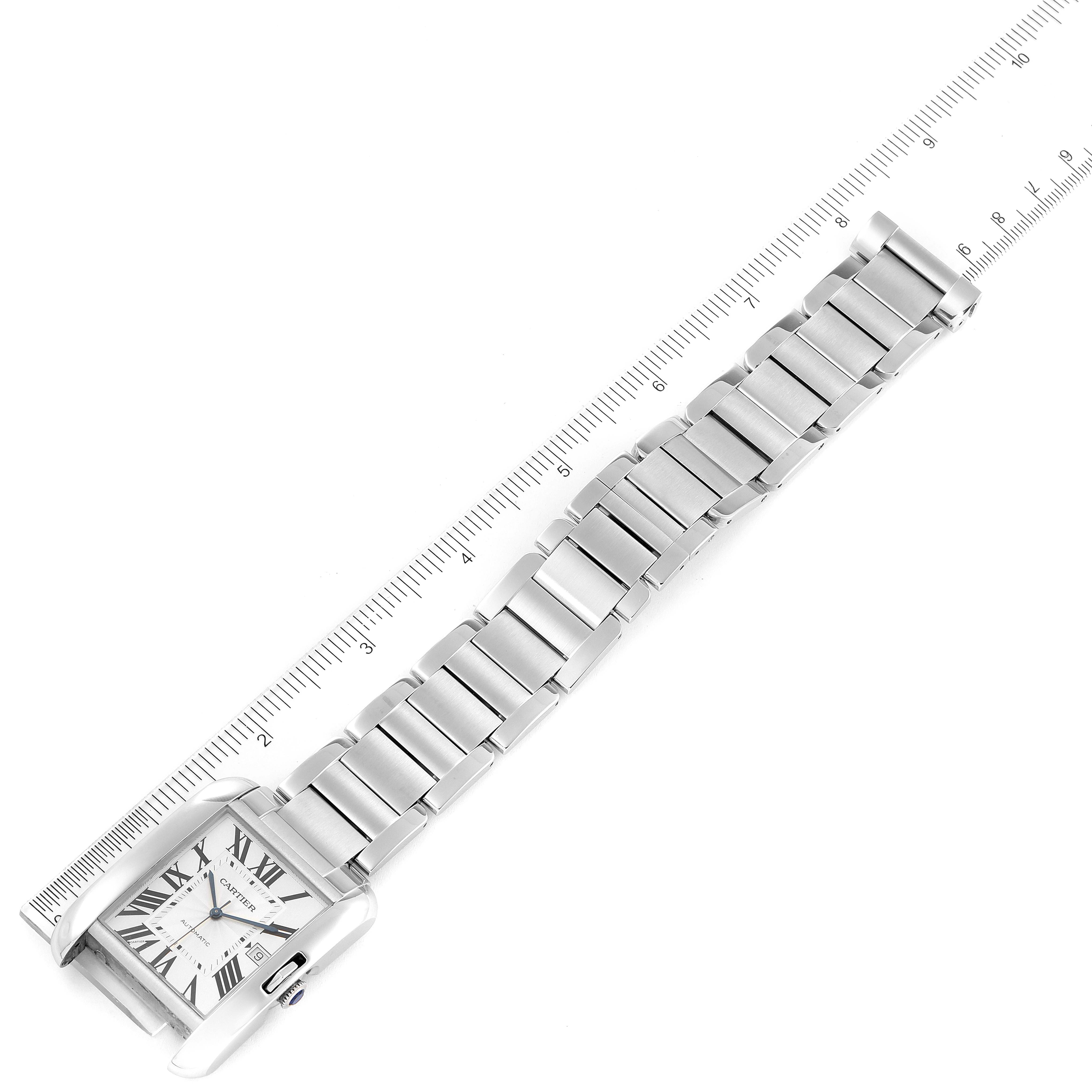 The image shows a top view of the Cartier Tank Anglaise W5310008 Men's Stainless Steel Silver Dial W5310008 Men's Stainless Steel Silver Dial watch, including the rectangular face and metal strap, beside a ruler for scale.