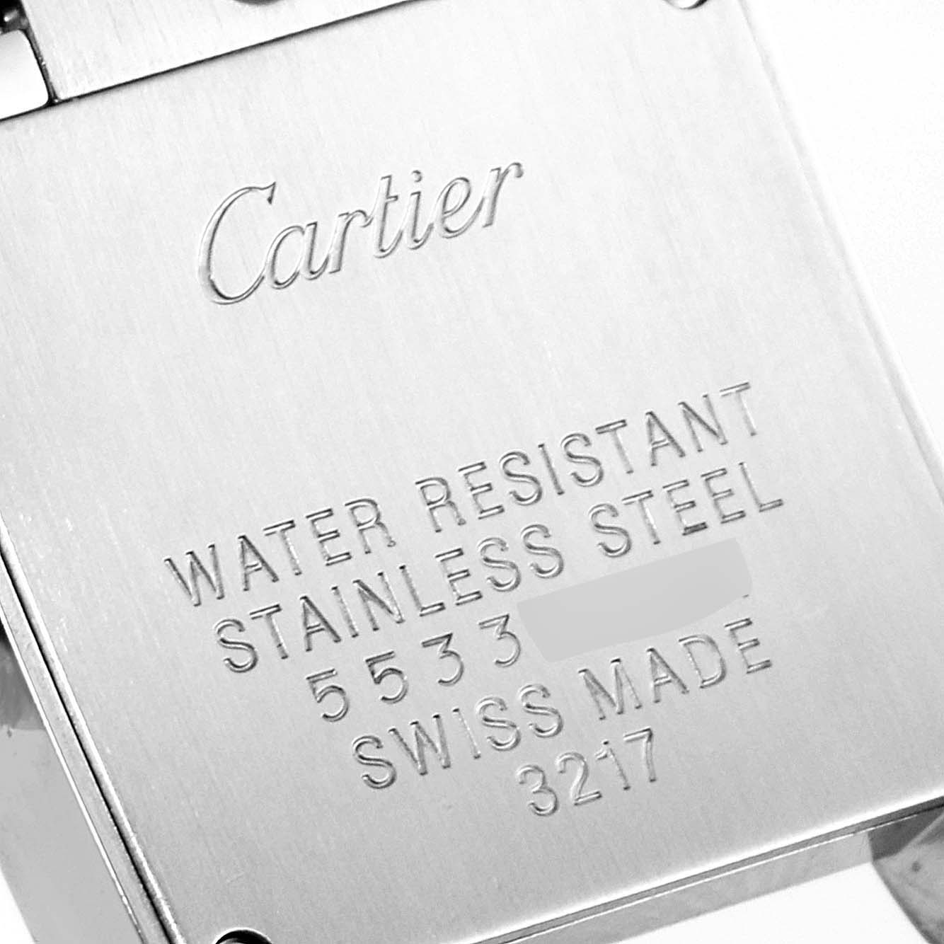 The image shows the back case of a Tank Francaise model by Cartier, highlighting engravings about water resistance and material.