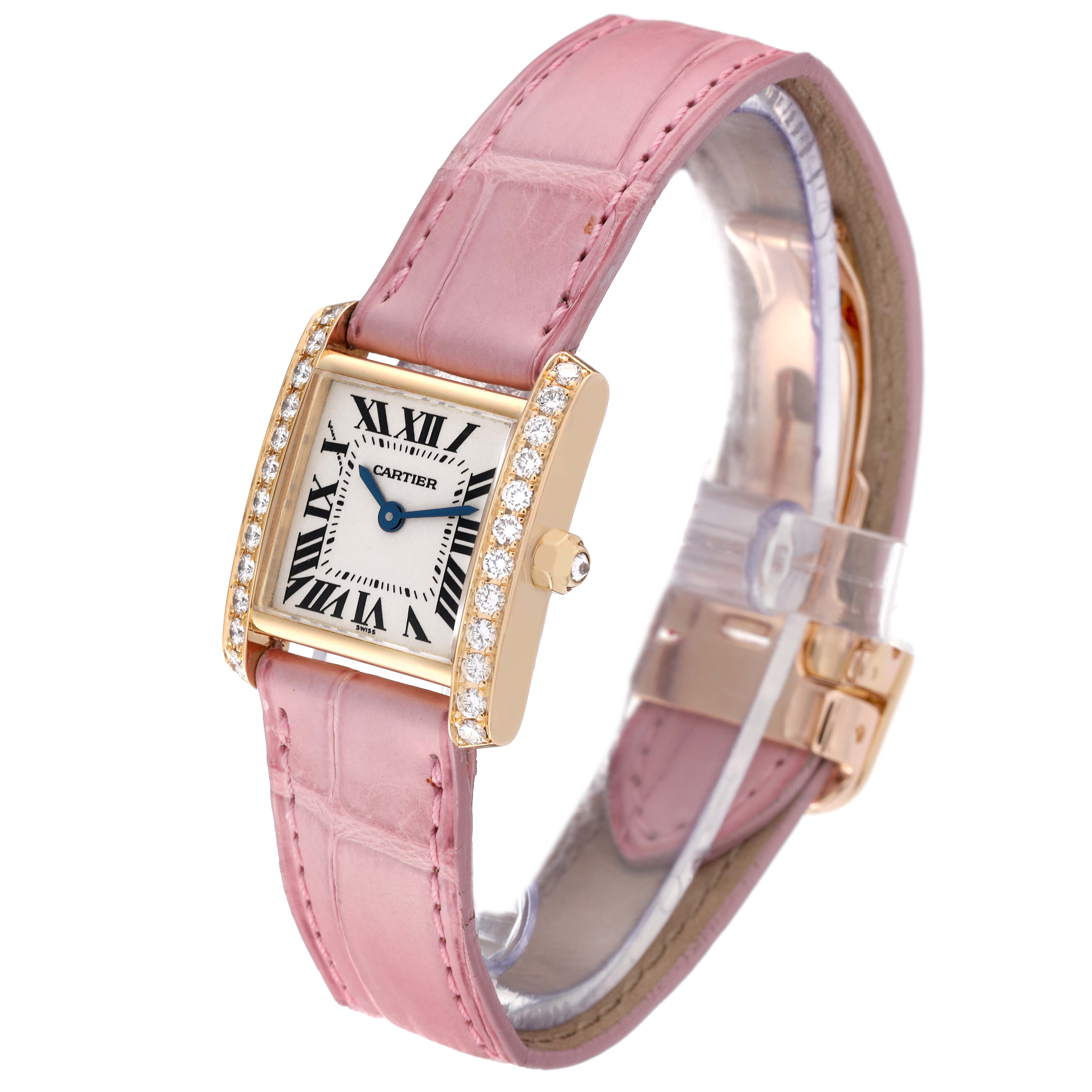 The image shows a Cartier Tank Française watch with a pink leather strap and diamond-set bezel, viewed from an angled side perspective.