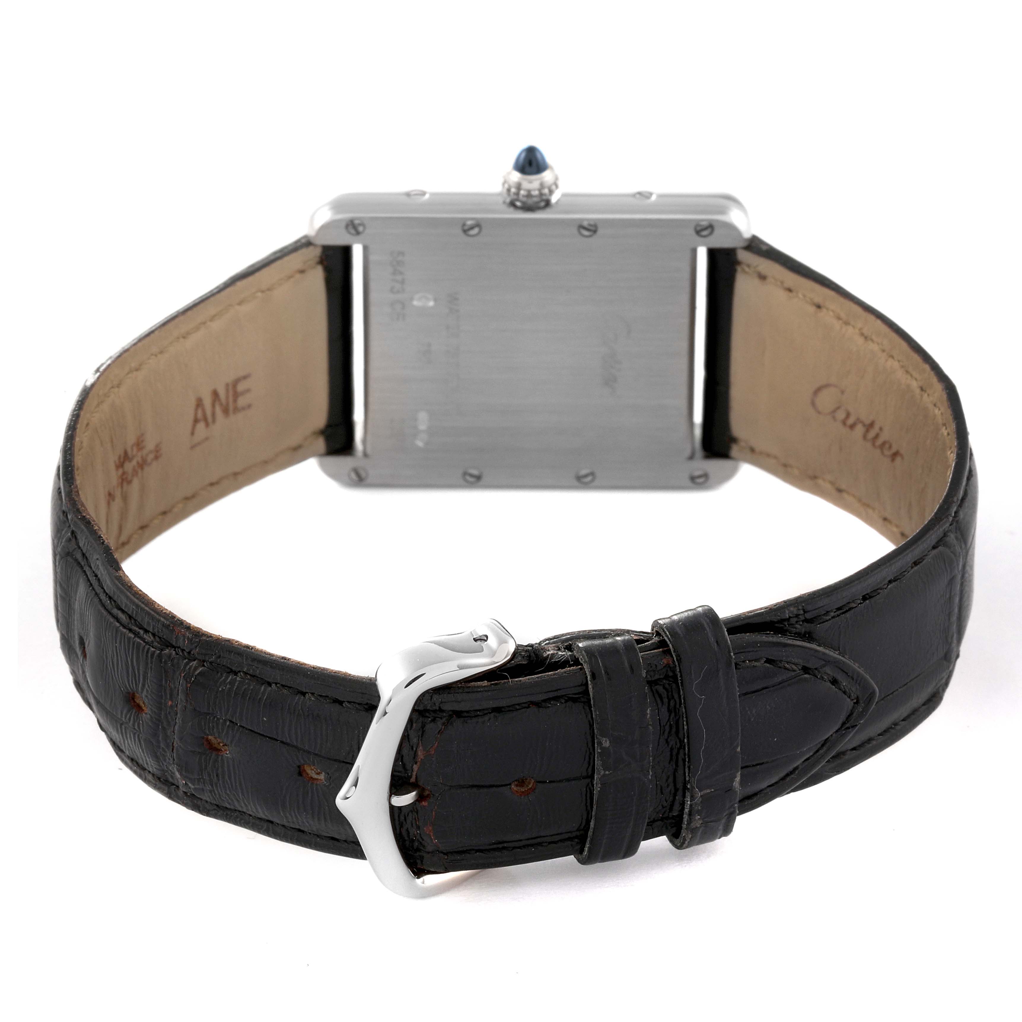 The image shows the Tank Louis Cartier watch from the back, highlighting the case back, crown, and leather strap with buckle.