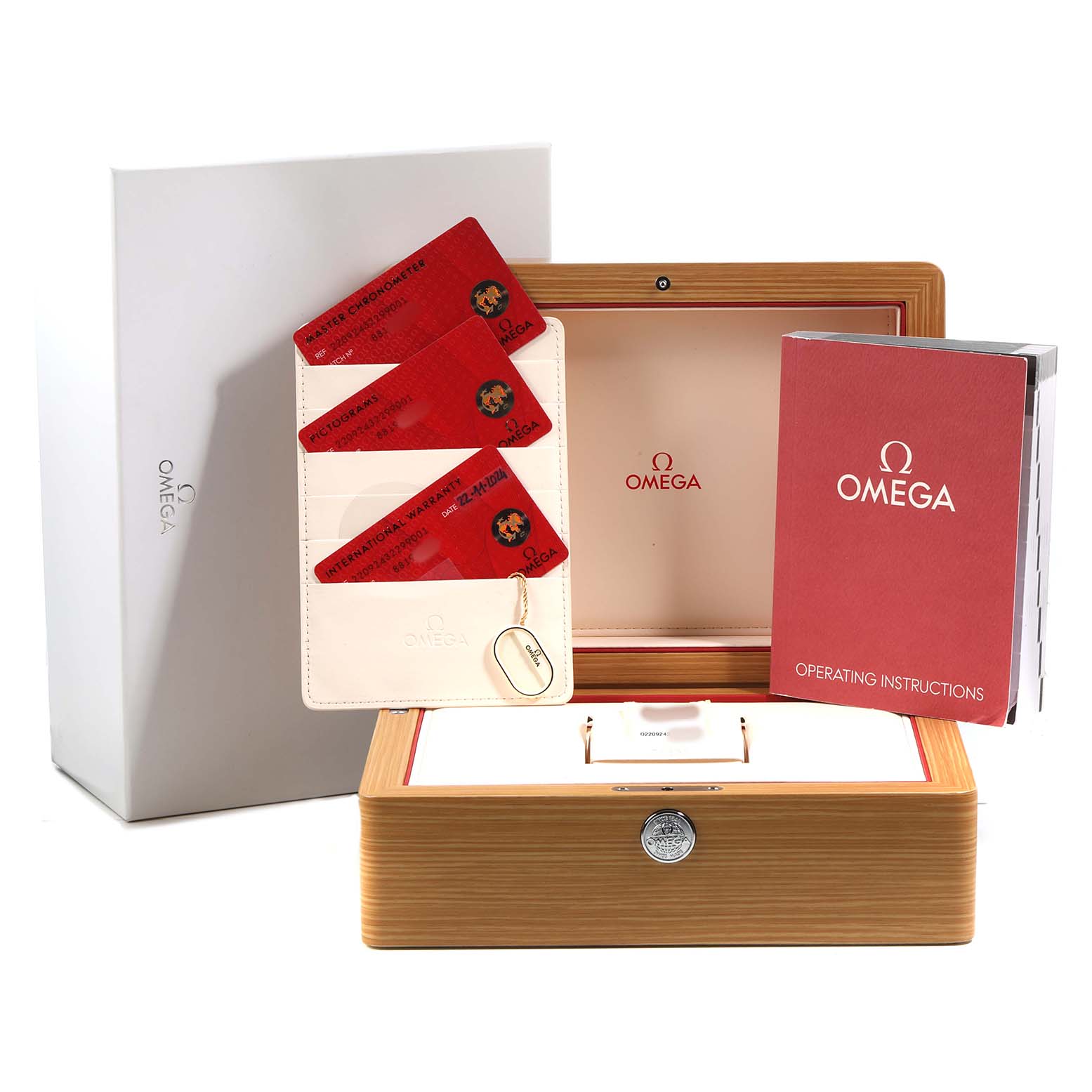 The image shows the packaging for the Omega Aqua Terra 220.92.43.22.99.001 Men's Titanium Black Dial, including the box, warranty cards, and operating instructions.