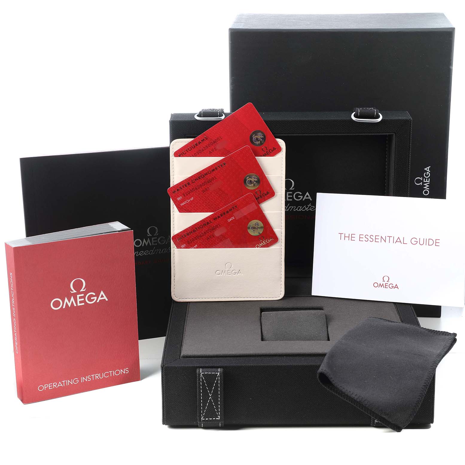 The image shows the Omega Speedmaster 310.30.42.50.04.001 Men's Stainless Steel White Dial packaging with manuals, warranty cards, and a cloth, all from an angled view.