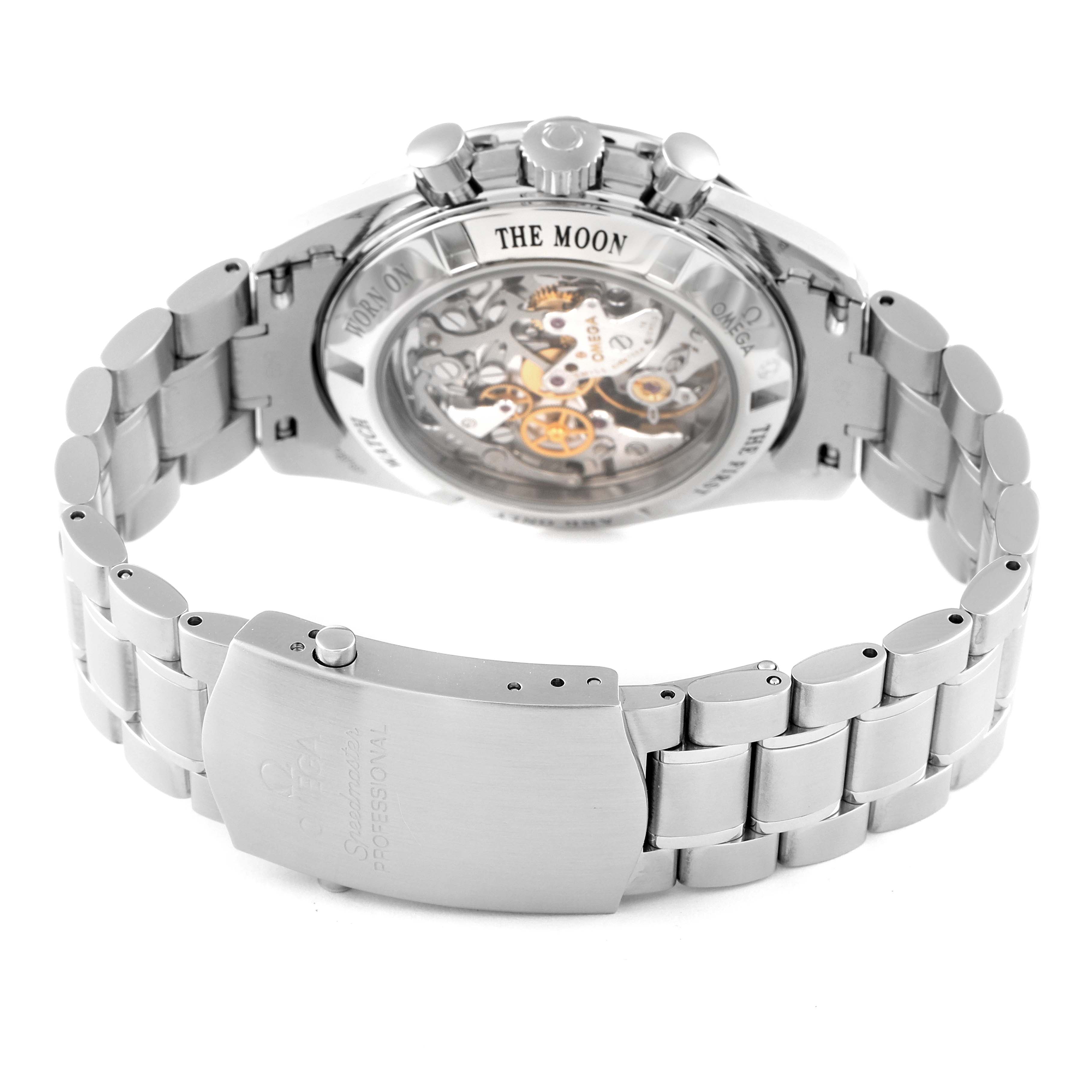 The image shows the back view of an Omega Speedmaster 3573.50.00 Men
s Stainless Steel Black Dial 3573.50.00 Men
s Stainless Steel Black Dial watch, highlighting the movement and bracelet clasp.