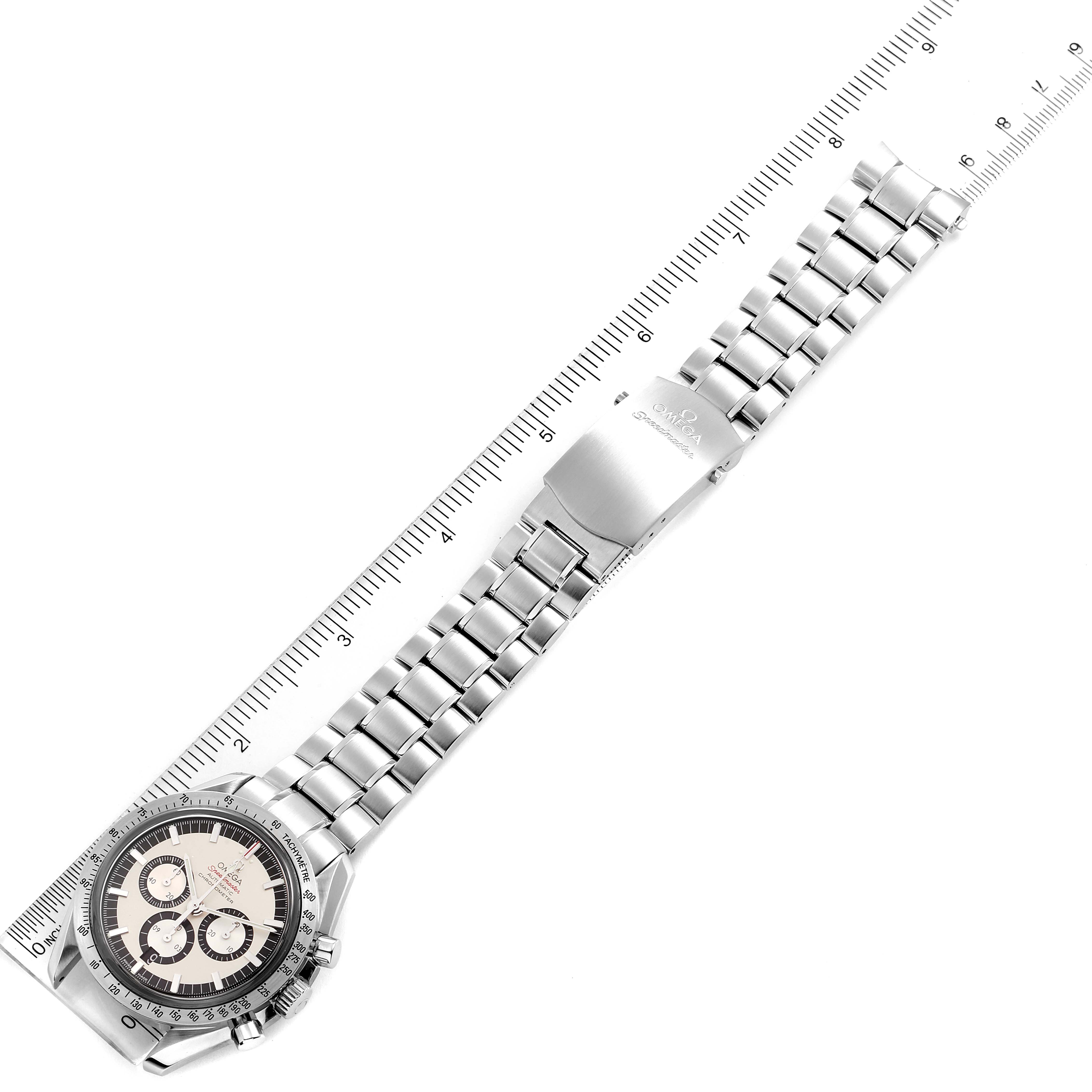 The image shows an Omega Speedmaster 3506.31.00 Men's Stainless Steel Silver Dial 3506.31.00 Men's Stainless Steel Silver Dial watch laid flat with its metal bracelet fully extended alongside a ruler.