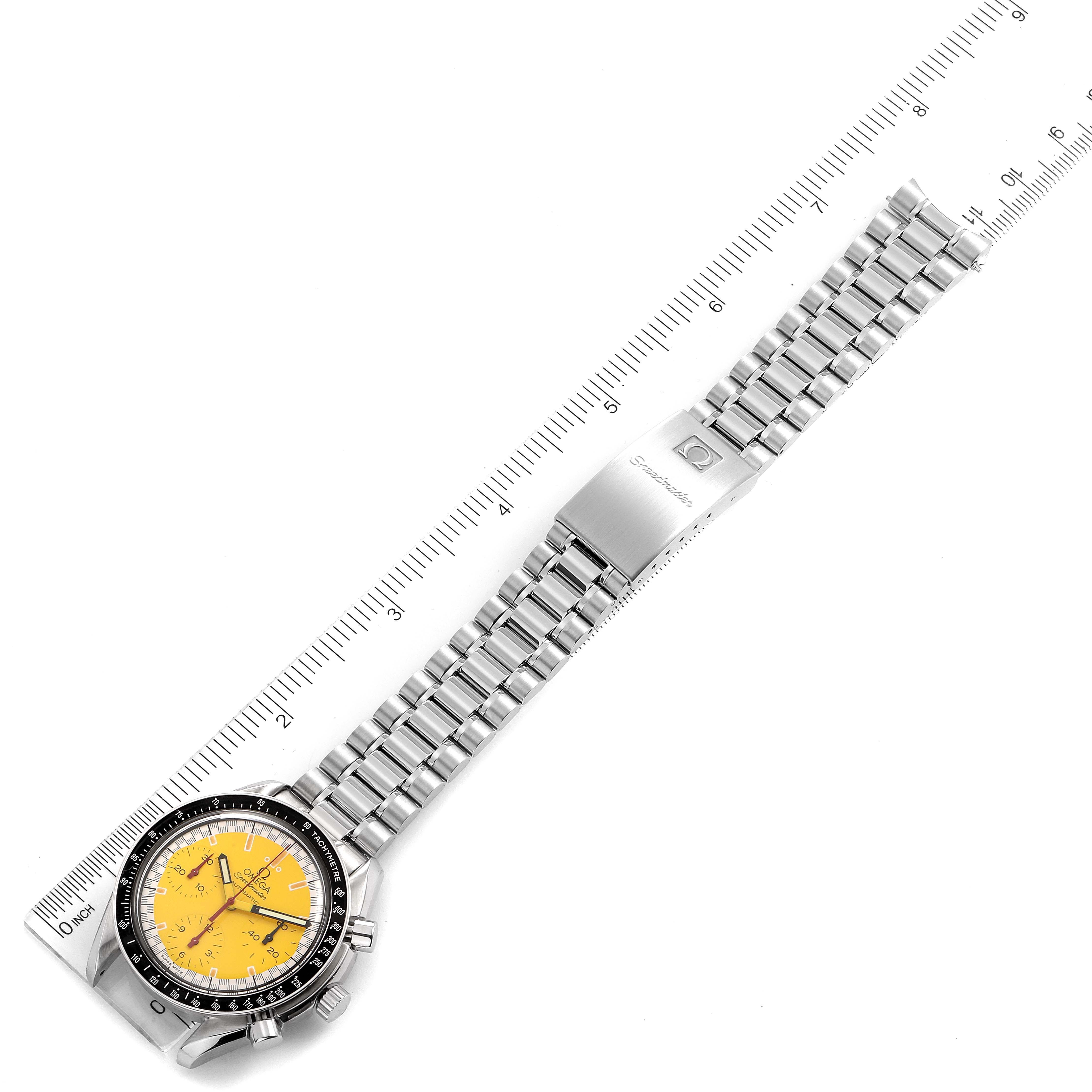The image shows an overhead view of an Omega Speedmaster 3510.12.00 Men's Stainless Steel Yellow Dial 3510.12.00 Men's Stainless Steel Yellow Dial watch displaying the face, bezel, and metal bracelet alongside a ruler.