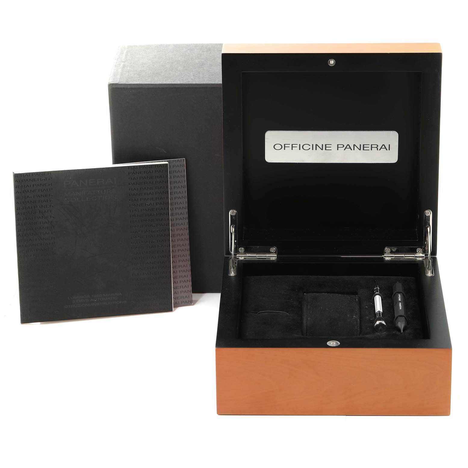 This image shows an open box for the Luminor model by Panerai, including tools and a booklet.
