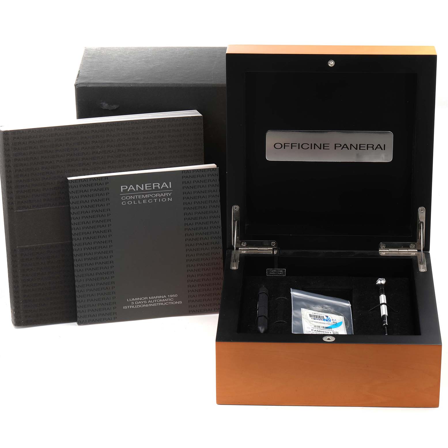 The image shows the accessories and packaging for a Luminor model by Panerai, including a box, manuals, and tools from a front angle.