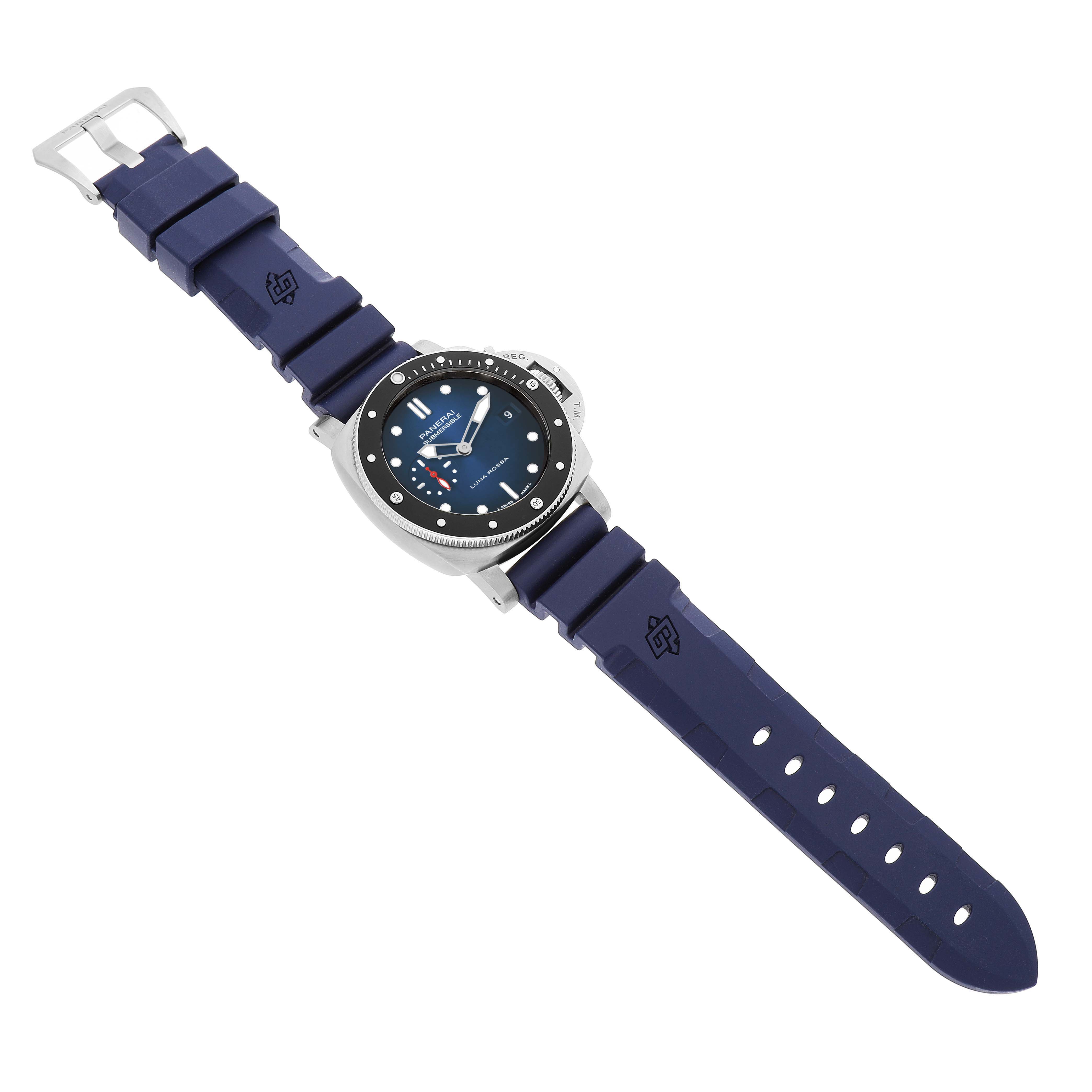 The Panerai Submersible PAM01565 Men's Stainless Steel Blue Dial watch is shown from a slightly angled top view, displaying its face and blue strap clearly.