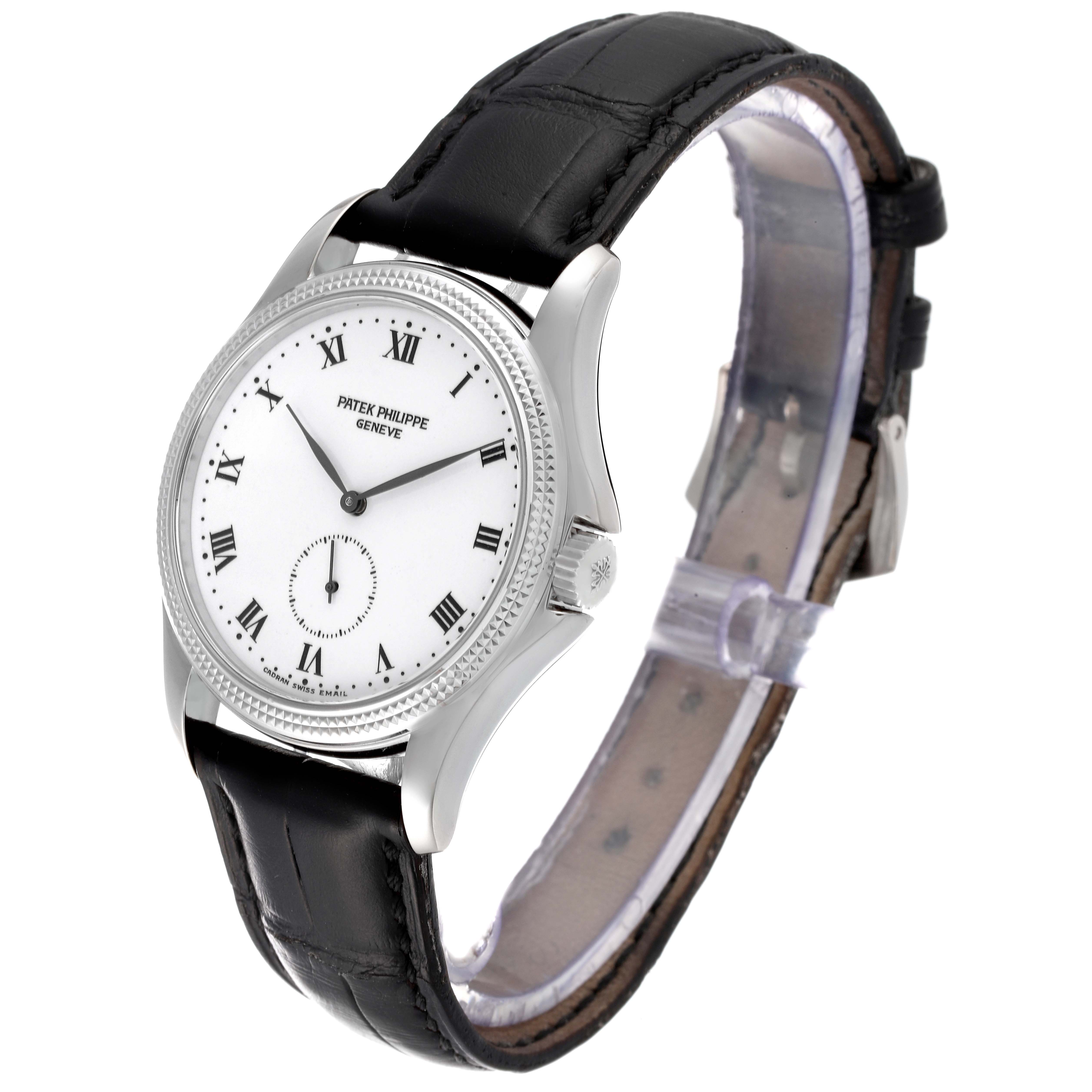 The image shows a Patek Philippe Calatrava 5115G-001 Men's White Gold White Dial 5115G-001 Men's White Gold White Dial watch at an angled side view, displaying the dial, case, and black leather strap.