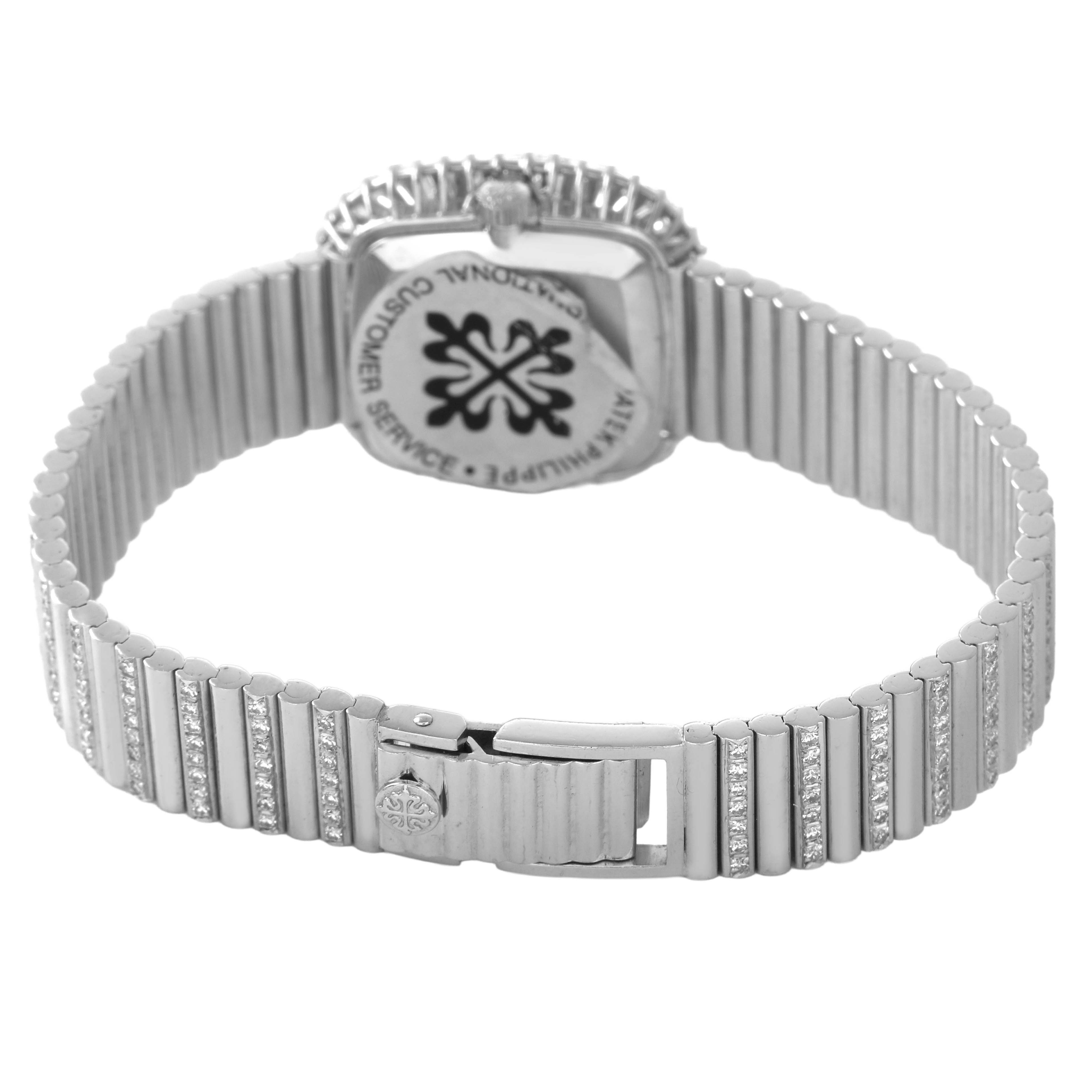 The image shows the back of a Patek Philippe Vintage 4432/1 Women's White Gold Black Dial watch, focusing on the clasp and bracelet with diamond accents.