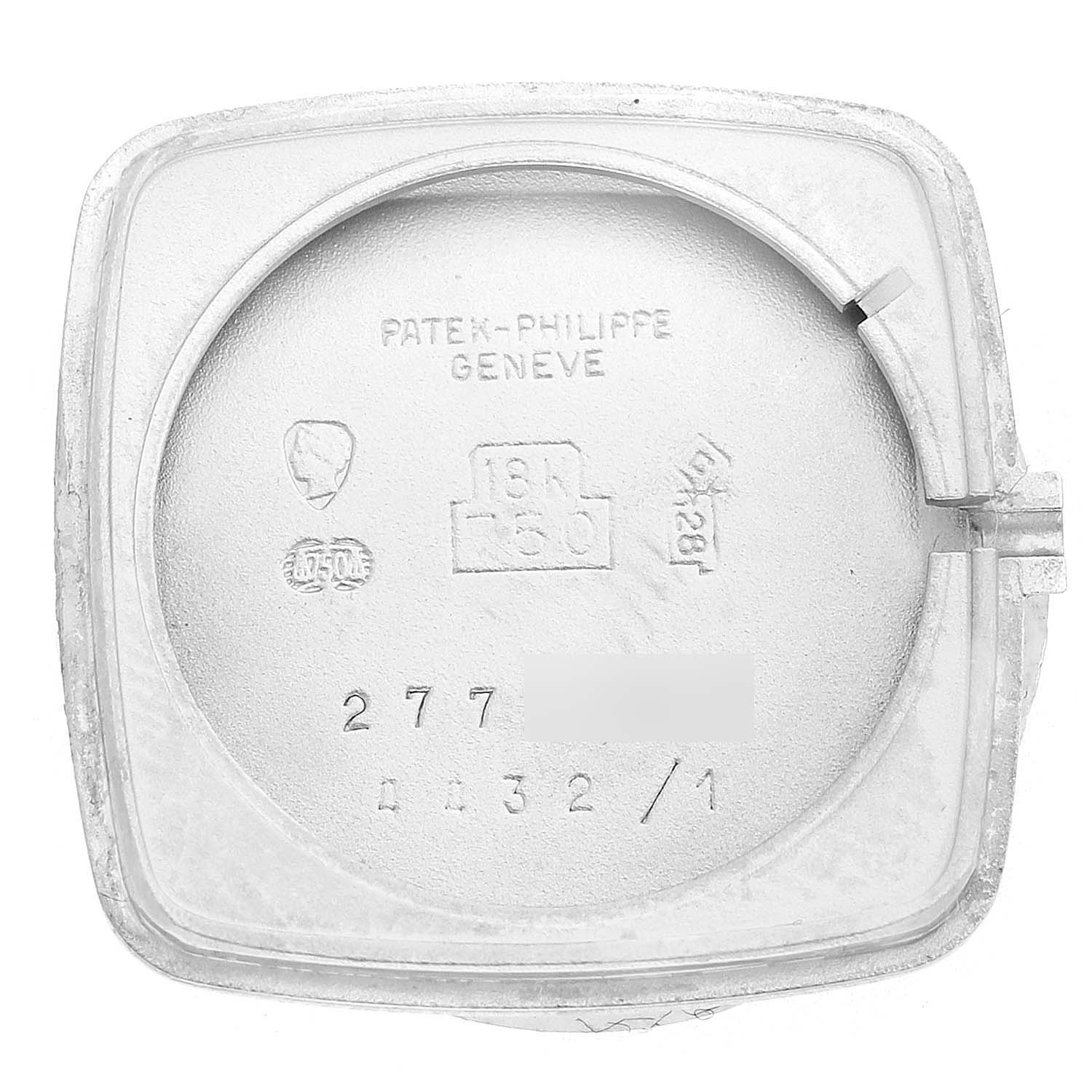 The image shows the inner case back of a Vintage Patek Philippe watch, featuring engravings and hallmarks.