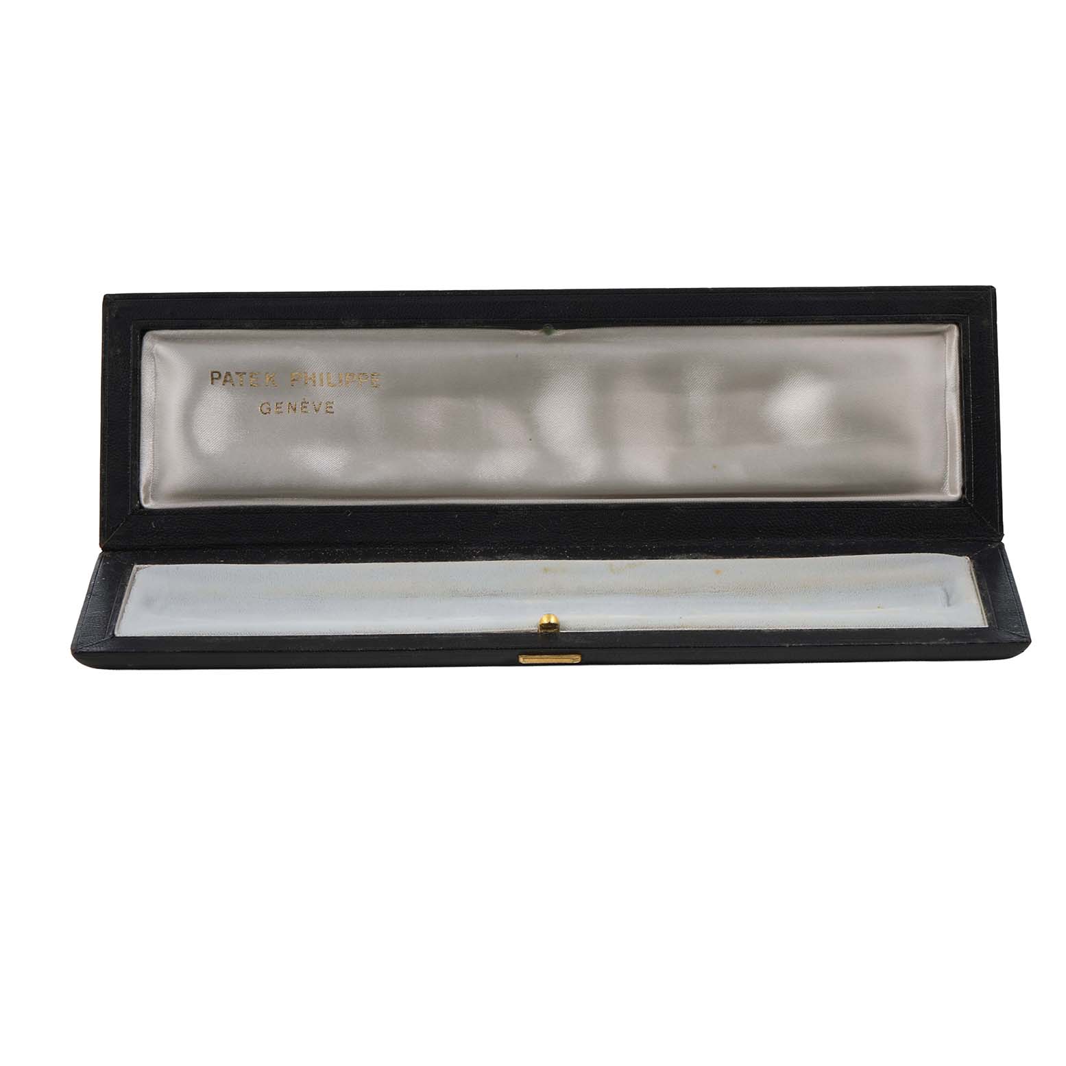The image shows an open Patek Philippe watch box, highlighting the interior with brand engraving.