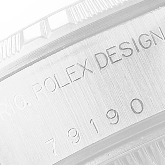The image shows a close-up of the side engraving on a Rolex Date 79190 Women
s Stainless Steel Black Dial 79190 Women
s Stainless Steel Black Dial watch, displaying the design and model number.