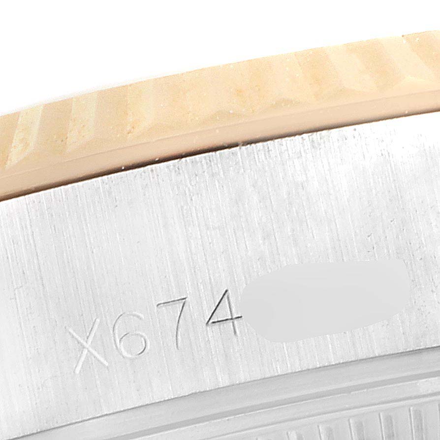 This image shows a close-up of the case and bezel of a Rolex Datejust 69173 Women's Steel and Gold (two tone) Champagne Dial 69173 Women's Steel and Gold (two tone) Champagne Dial, focusing on the engraved serial number.